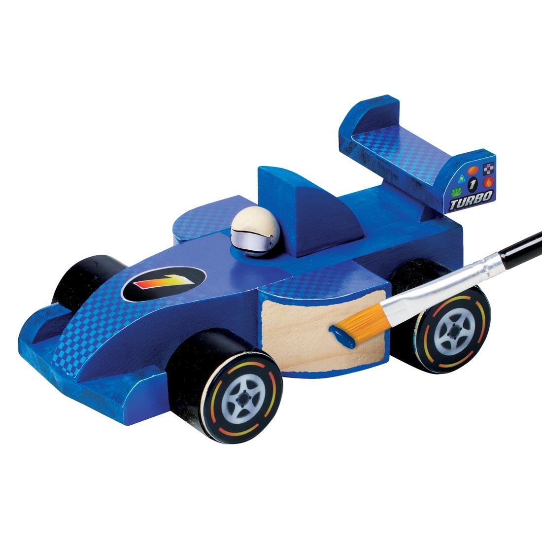 car from Buildeez! Race Car Model Kit almost complete, shown with paintbrush