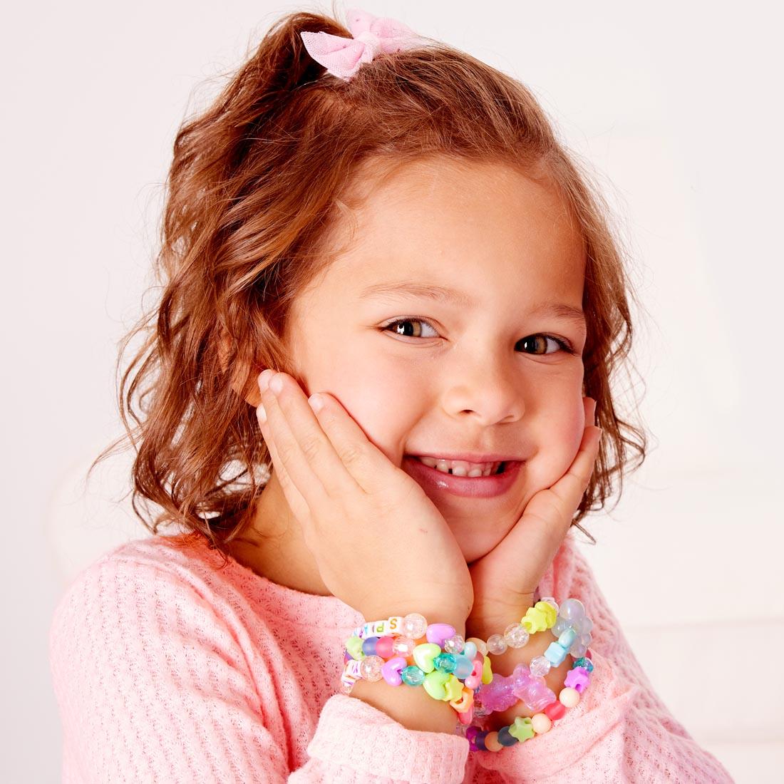 child wearing bracelets made with the Unicorn Bead Jewelry Jar