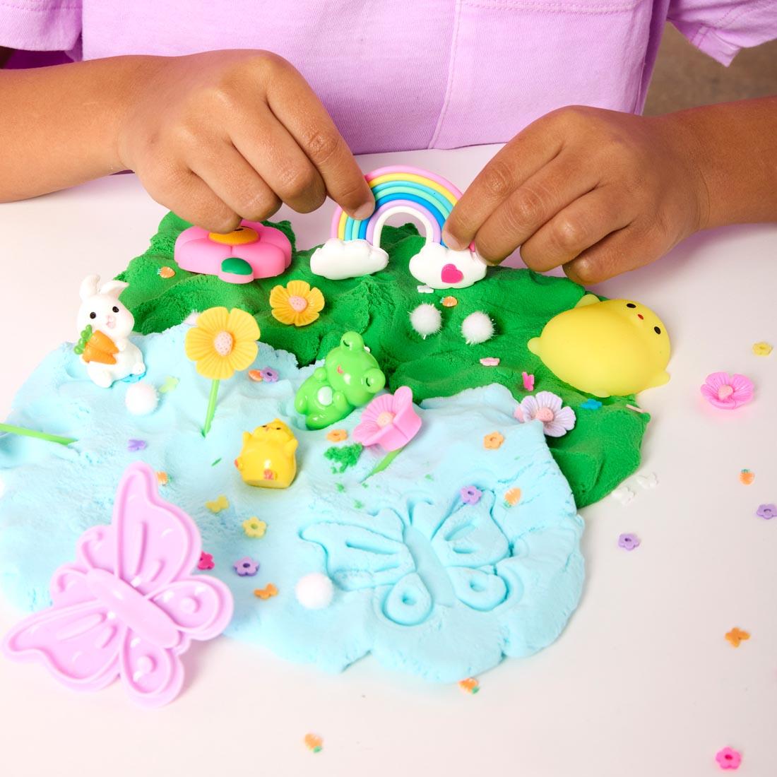 hands playing with Garden Friends Sensory Pack, showing cloud clay and various pieces