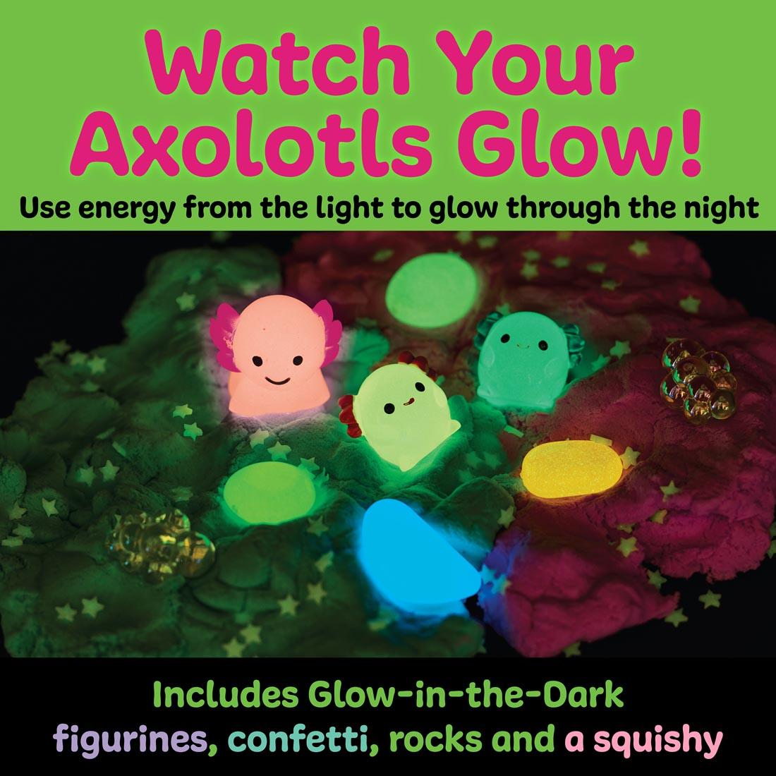 Some contents of the Axolotl Sensory Pack, showing glow-in-the-dark figurines, rocks and confetti, with the words: Watch Your Axolotls Glow!