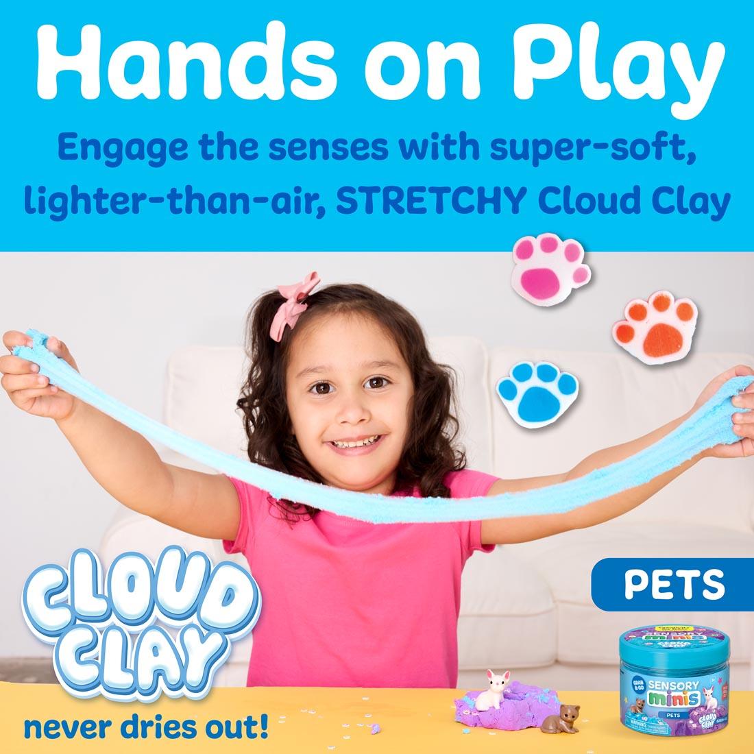 Young girl stretching light blue cloud clay, with the words: Hands on Play; Engage the senese with super-soft, lighter-than-air stretchy cloud clay