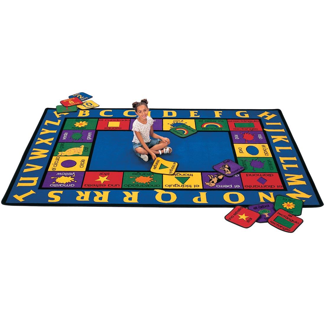 Child matching the squares of the Bilingual Rug by Carpets For Kids