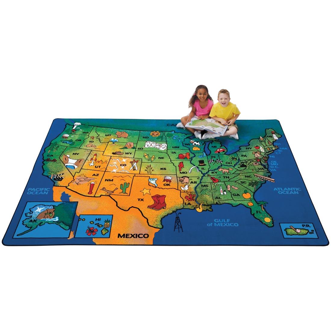 Children sitting with a book on the USA Learn & Play Rug by Carpets For Kids