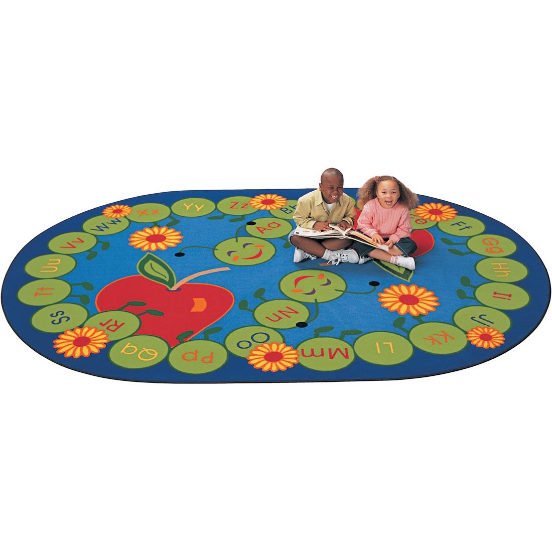 Children sitting with a book on the ABC Caterpillar Oval Rug by Carpets For Kids