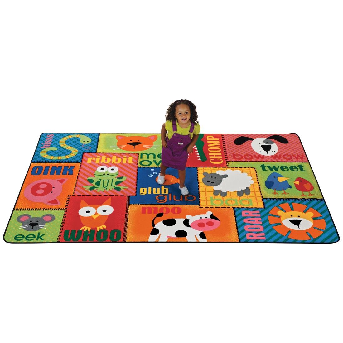 Animal Sounds Rectangular Toddler Rug by Carpets For Kids with young girl sitting on rug