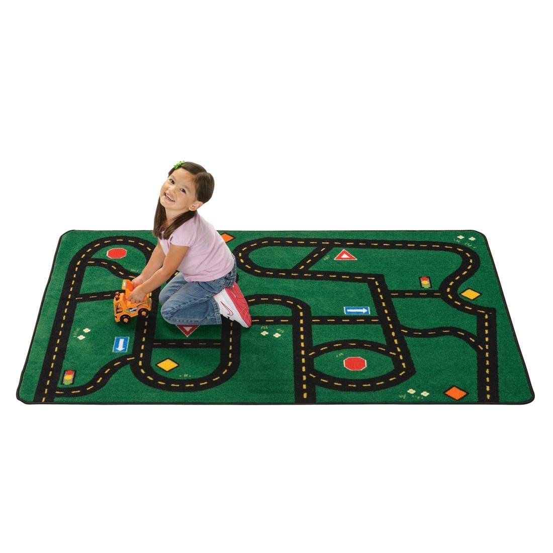 Road Kids Value Rug by Carpets For Kids, with a young girl playing on the rug with a toy dump truck