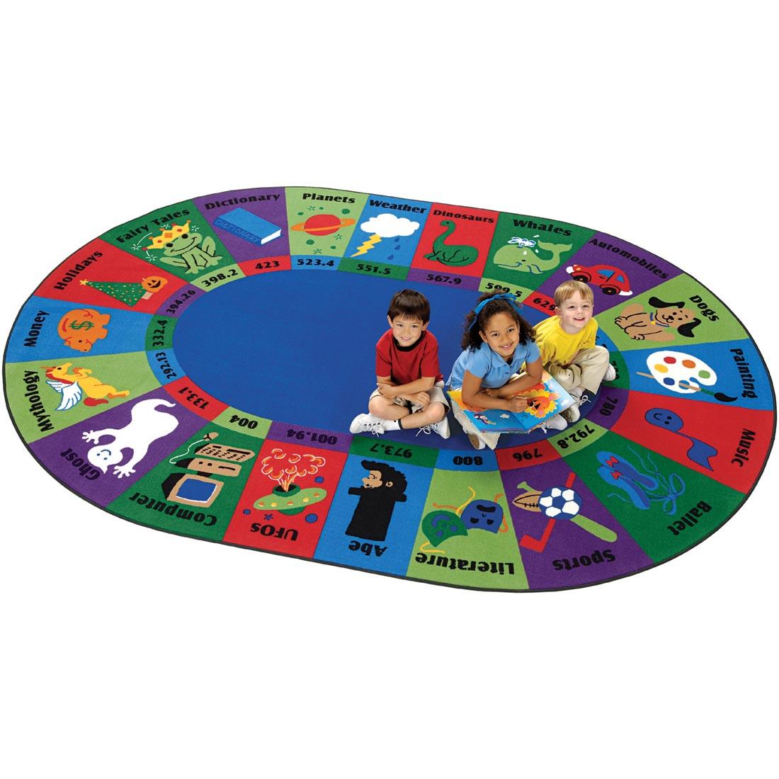 Children sitting on the Dewey Decimal Fun Rug by Carpets For Kids