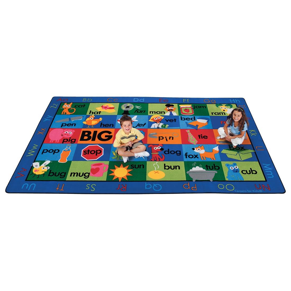 Children sitting on the Rhyme Time Rug by Carpets For Kids