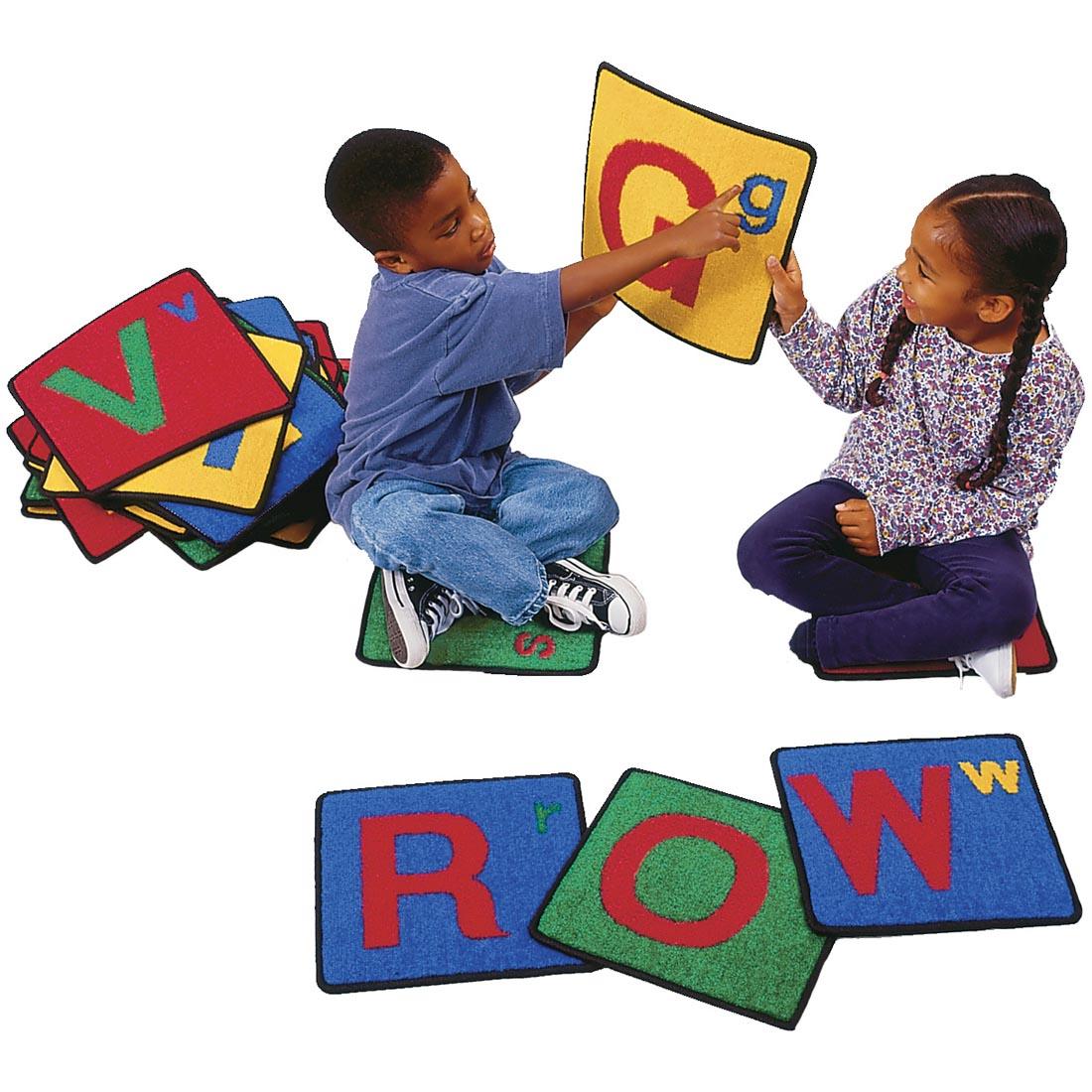 Children sitting with the Alphabet Rug Squares by Carpets For Kids