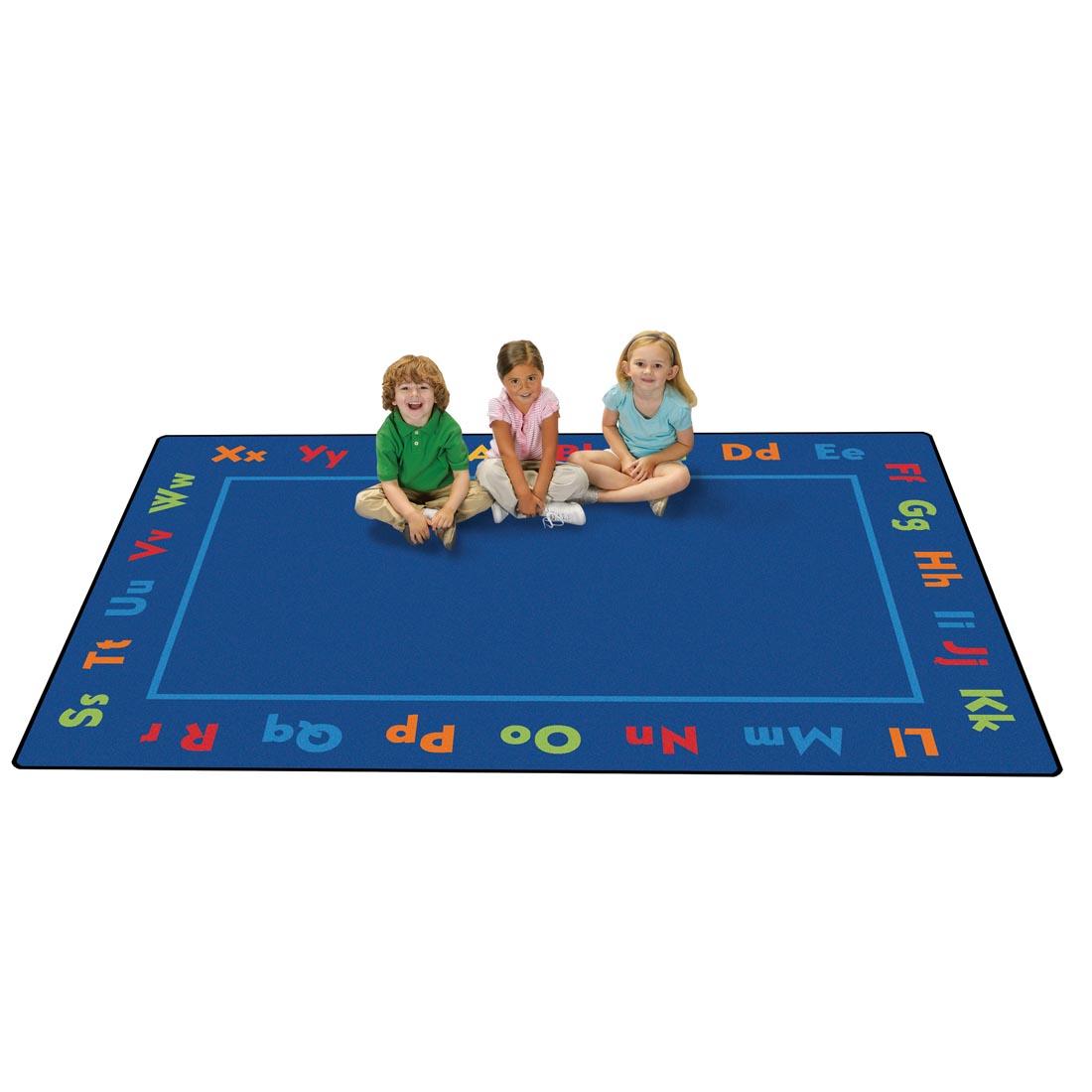 Alphabet Kids Value Plus Rug by Carpets For Kids, with 3 young children sitting on the rug