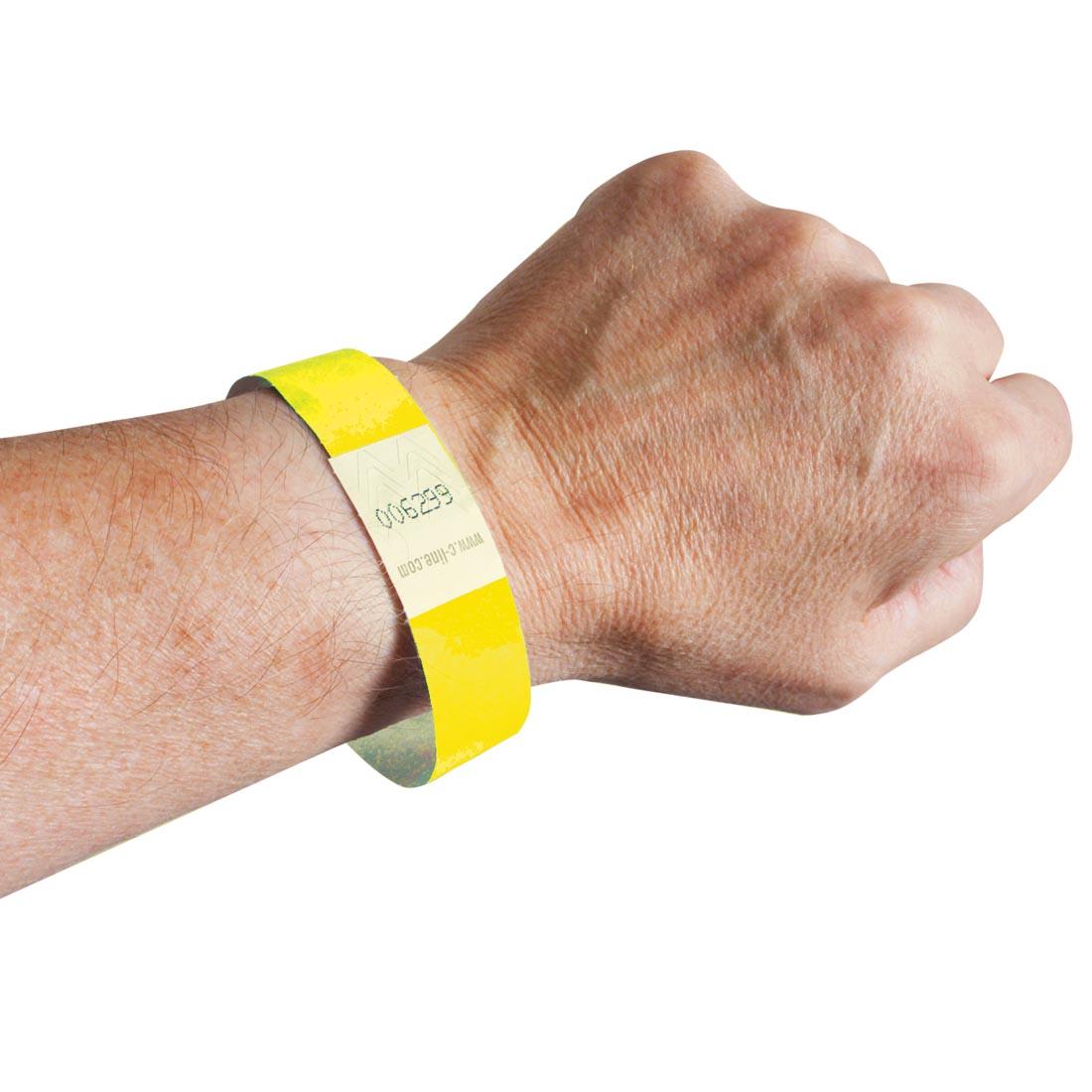 Yellow DuPont Tyvek Security Wristband on a wrist