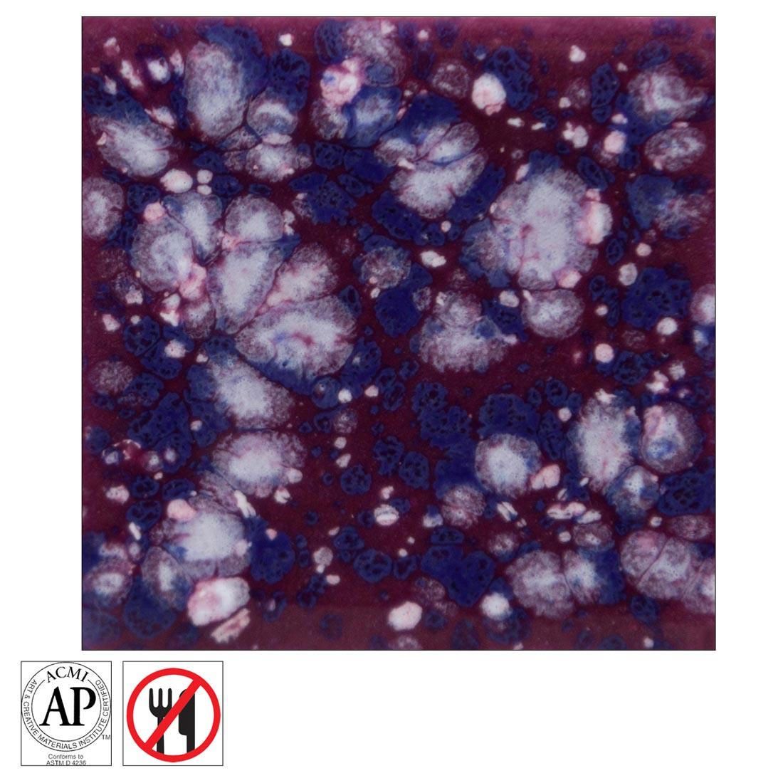 Clay tile with Plum Jelly Mayco Jungle Gems Crystal Glaze applied, plus the AP Seal symbol and the non-food safe symbol
