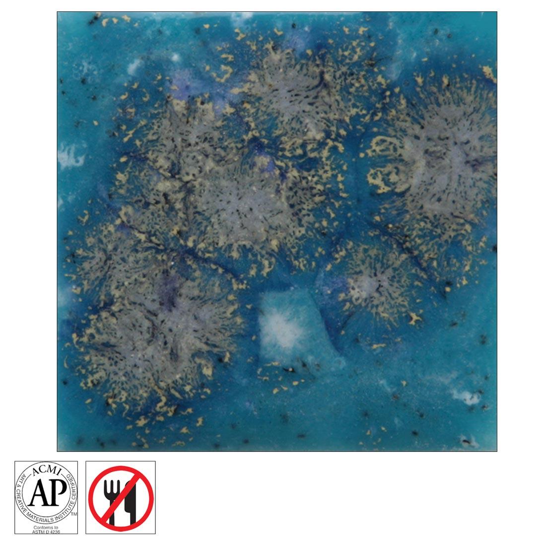 Clay tile with Tahiti Grape Mayco Jungle Gems Crystal Glaze applied, plus the AP Seal symbol and the non-food safe symbol