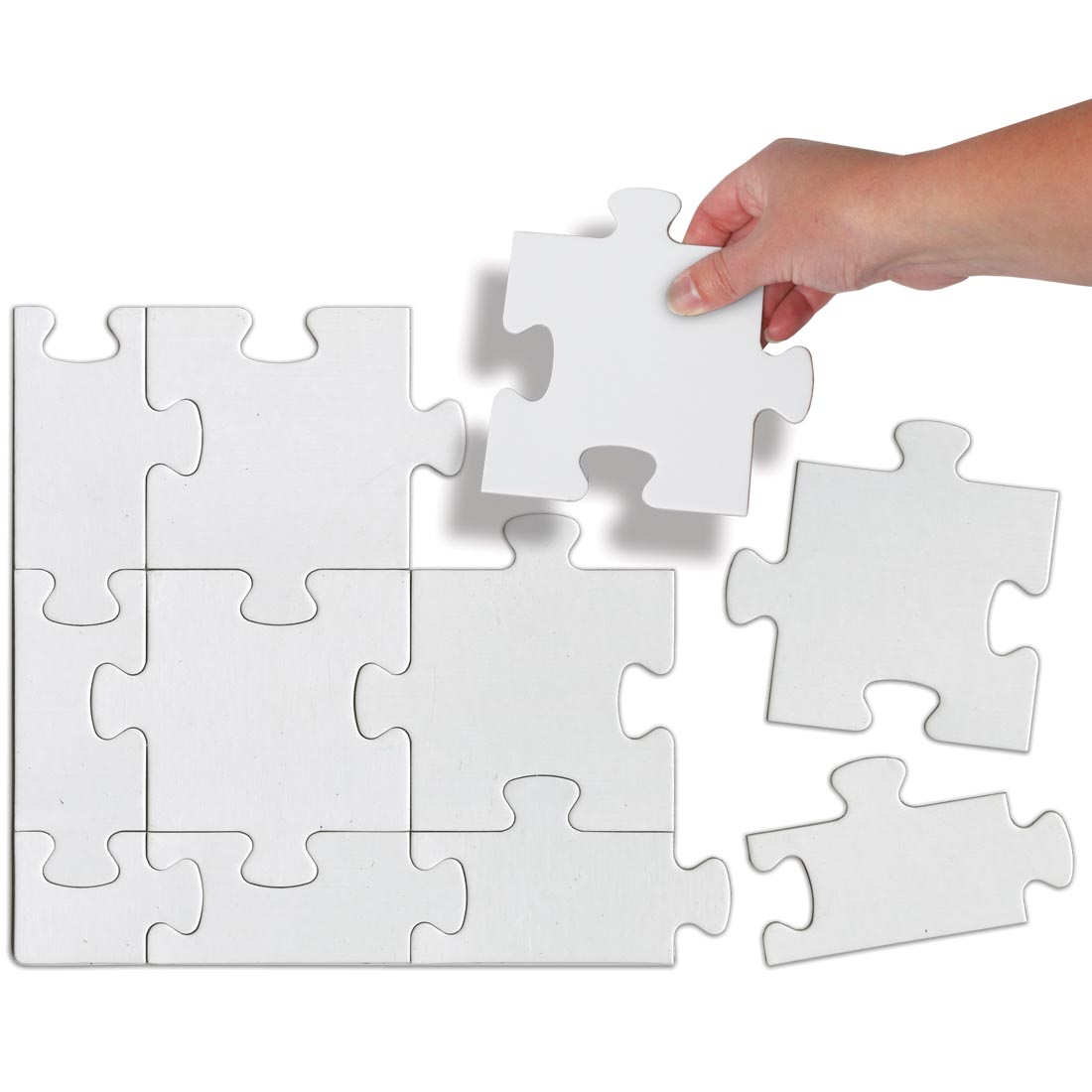 A hand putting in a piece of the blank Compoz-A-Puzzle Community Puzzle