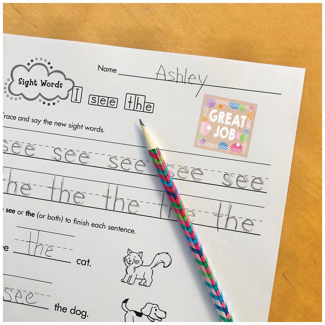 the Great Job sticker from Colorful Kraft Reward Stickers from the Krafty Pop Collection By Creative Teaching Press on a student's paper