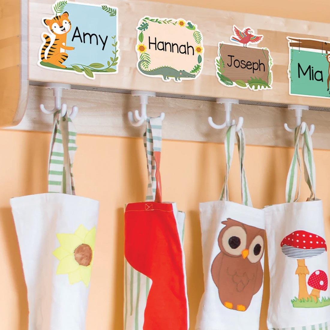 classroom bag hooks labeled with student names using Designer Cut-Outs from the Jungle Friends collection by Creative Teaching Press