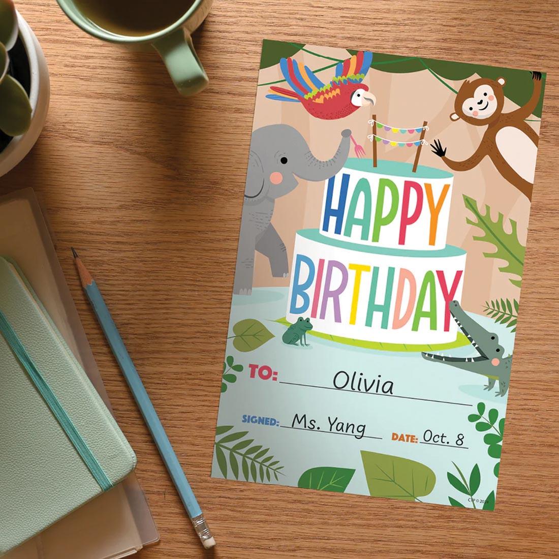 Happy Birthday Award from the Jungle Friends collection by Creative Teaching Press on a desk with names written in