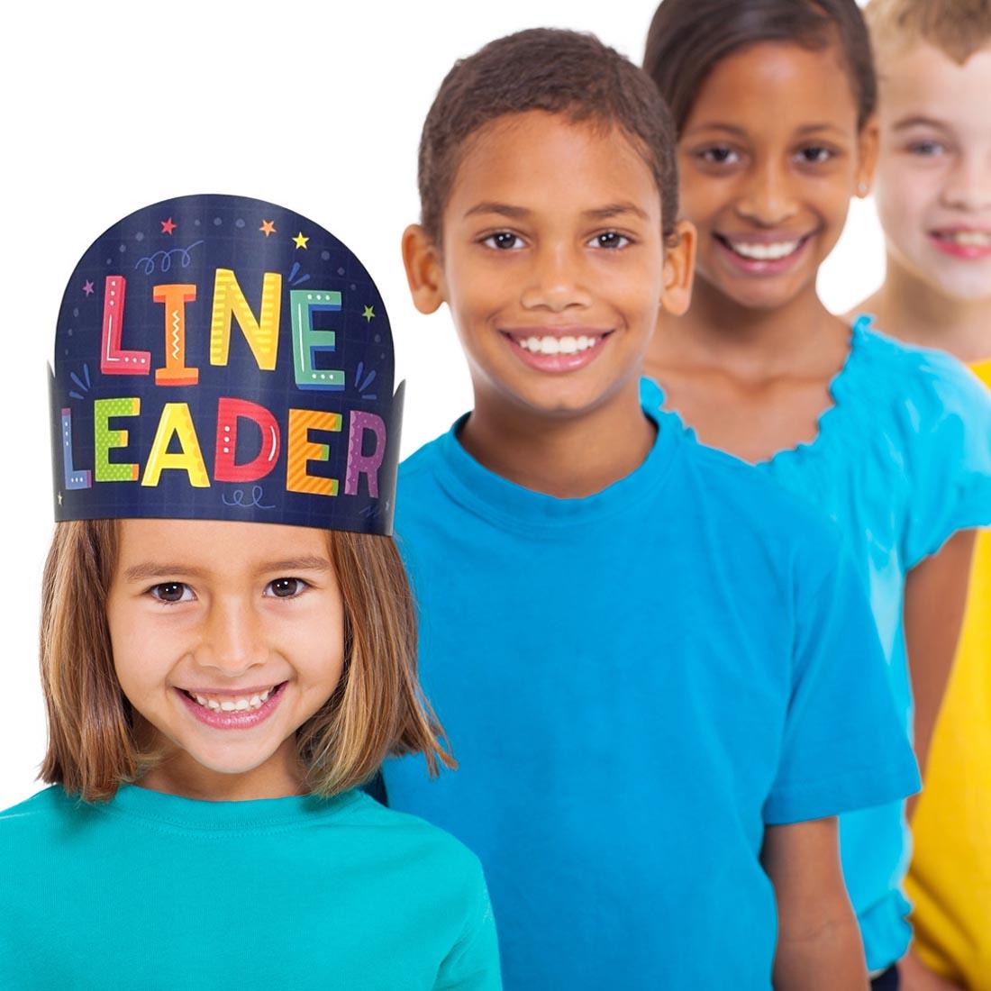 4 children, the first one wearing a Line Leader Crown from the Core Decor collection by Creative Teaching Press