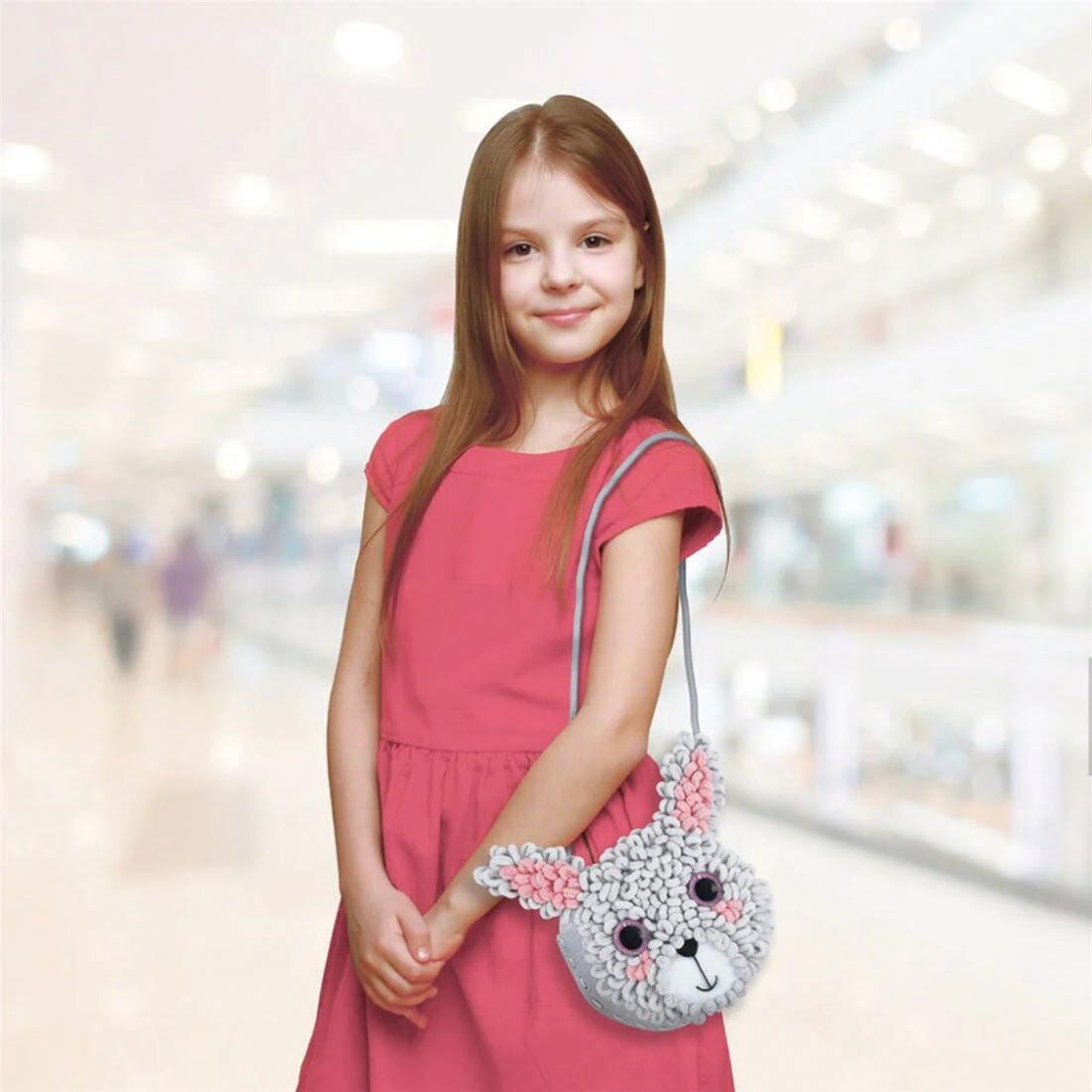 child with a Bunny Loopie Fun My First Plush Bag By Avenir on their shoulder