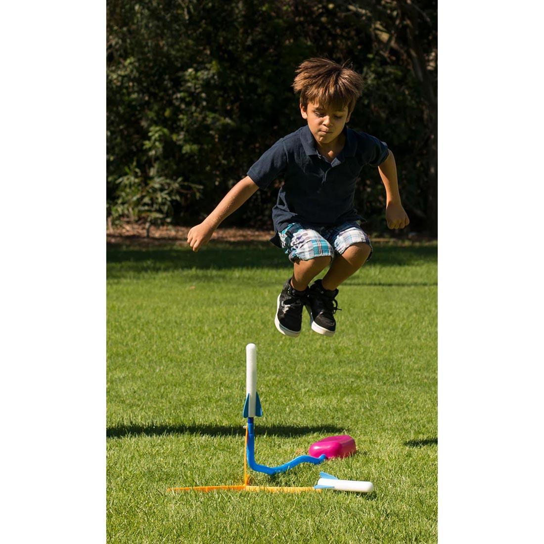 child jumping onto a Stomp Rocket Jr. Glow Rocket