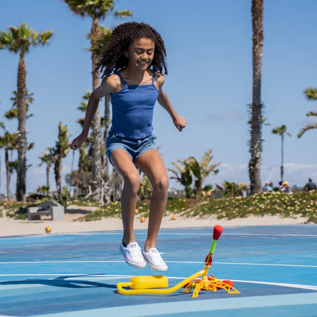 child jumping above a Stomp Rocket Ultra Rocket