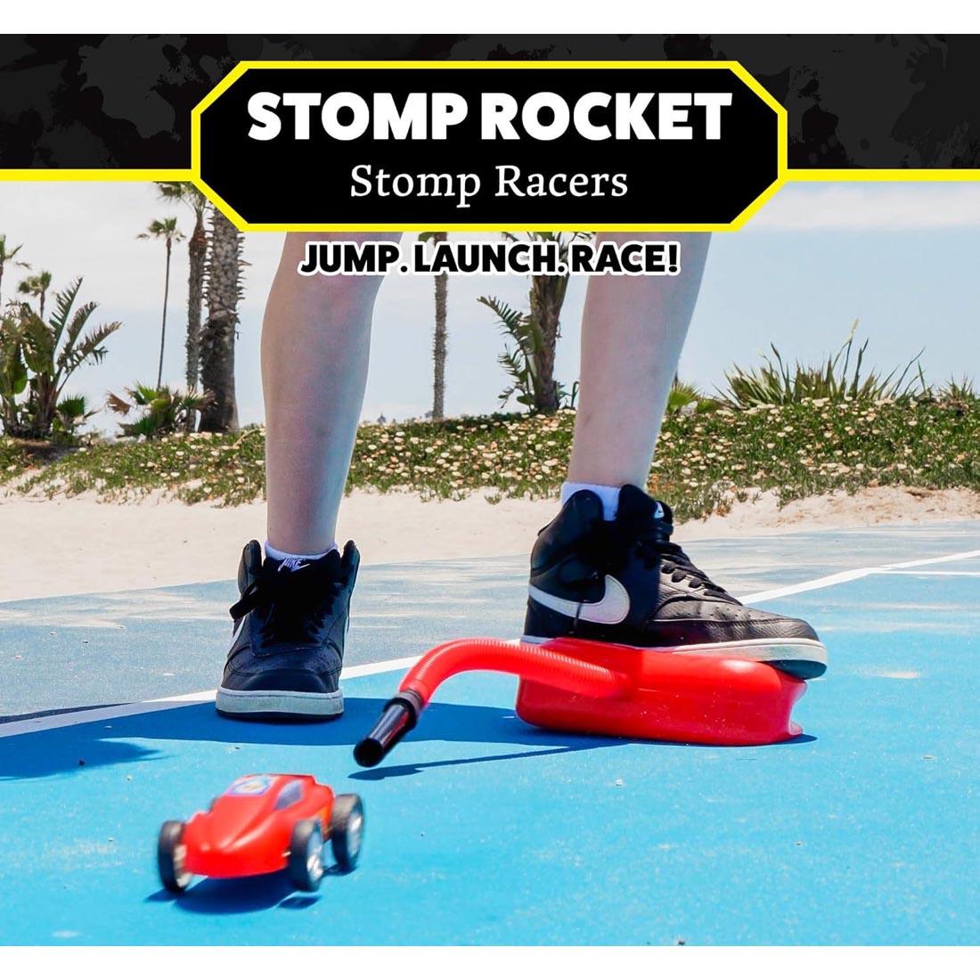 feet on a Stomp Rocket Dueling Stomp Racer plus text Stomp Rocket Stomp Racers Jump. Launch. Race!