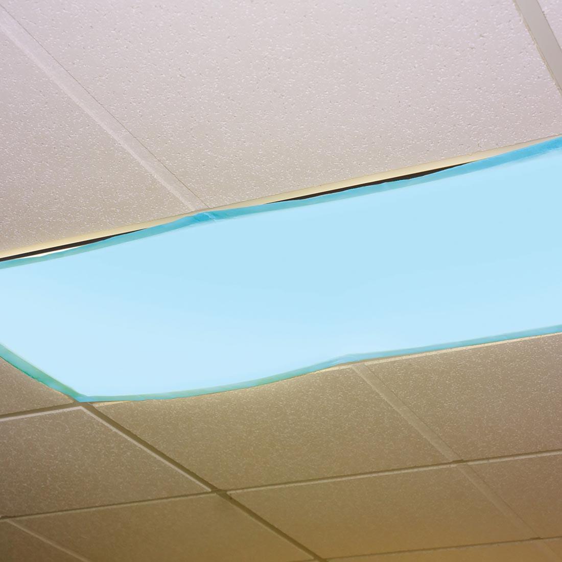 light blue filter over an overhead fluorescent light