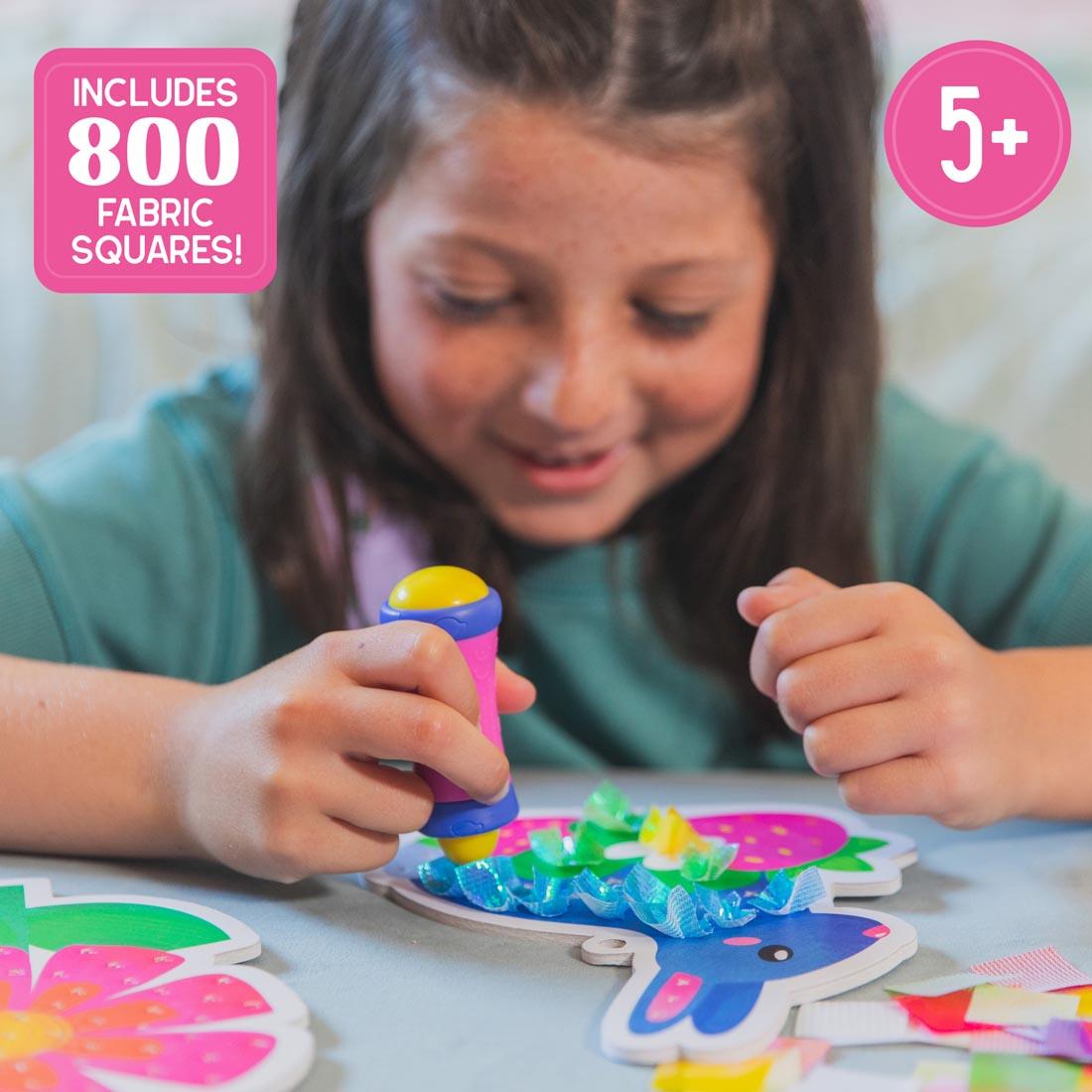 child using the Garden Magic Tufting Kit By Educational Insights plus text Includes 800 fabric squares!; 5+