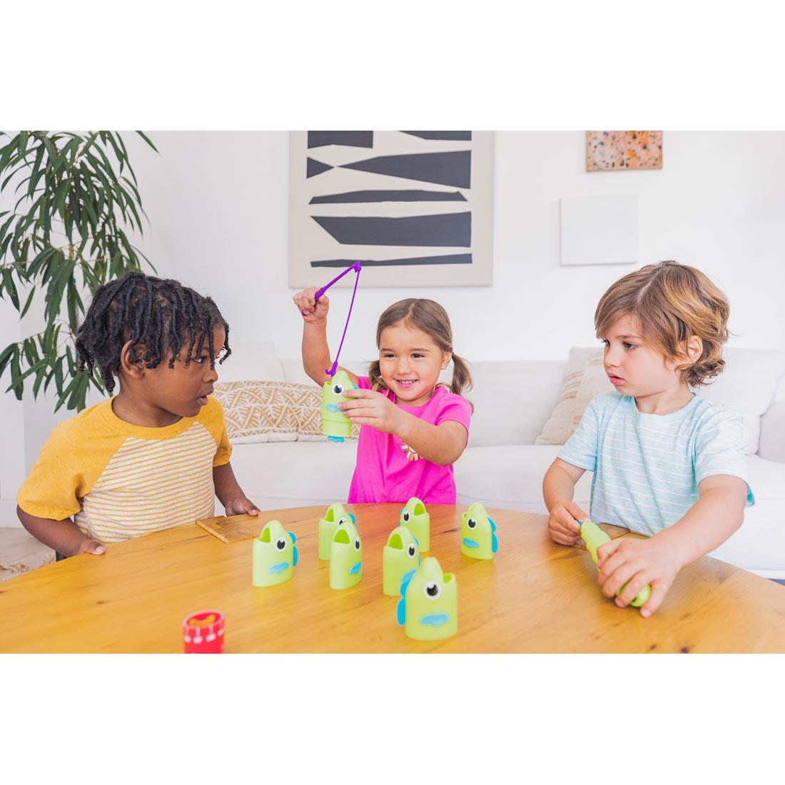3 children playing Reel Big Catch Game By Educational Insights