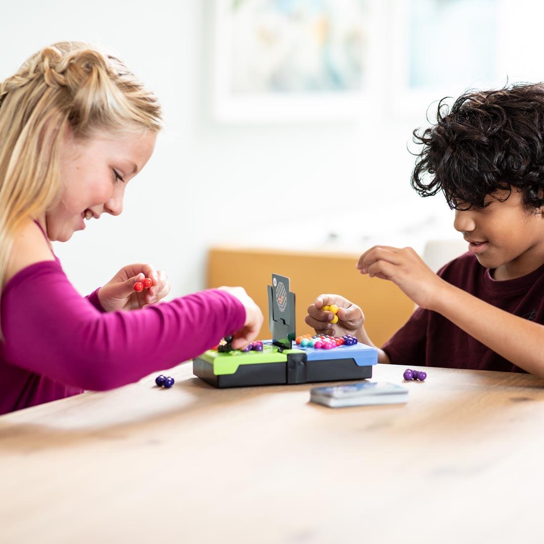 two children playing Kanoodle Head To Head Logic Game By Educational Insights