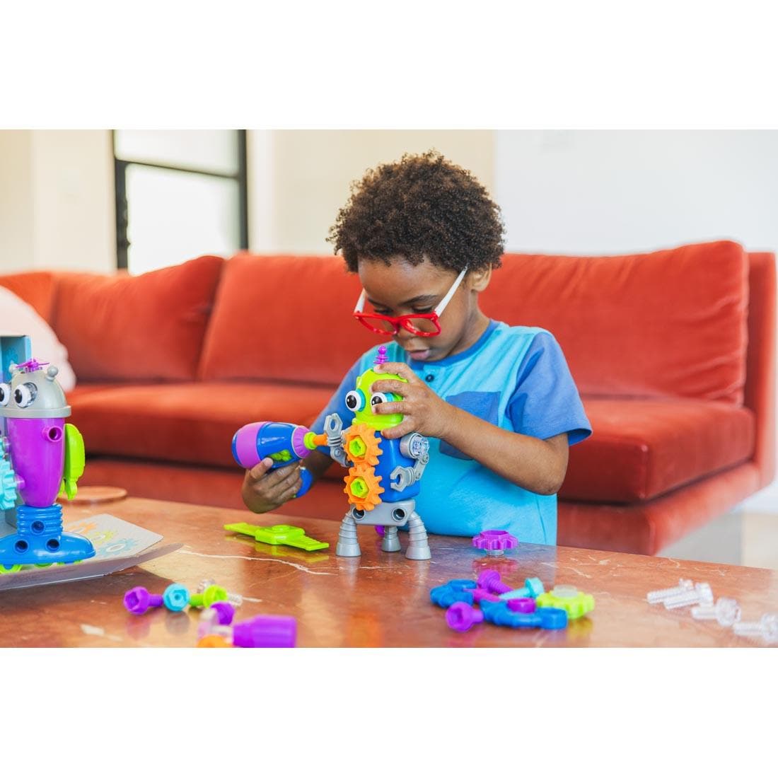 child playing with Design & Drill Robot Workshop