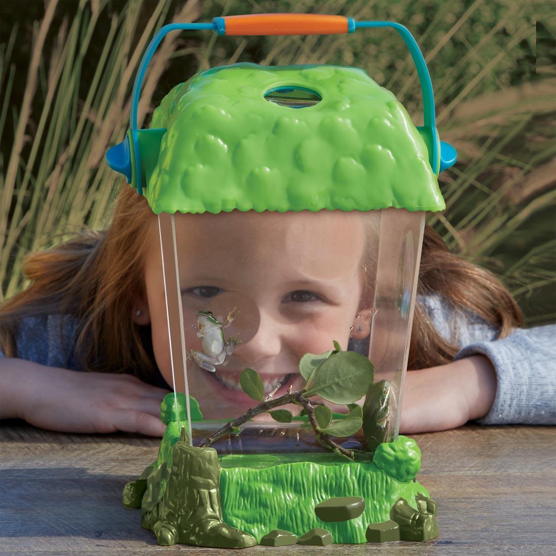 child enjoying viewing frogs up close in the GeoSafari Jr. Critter Habitat