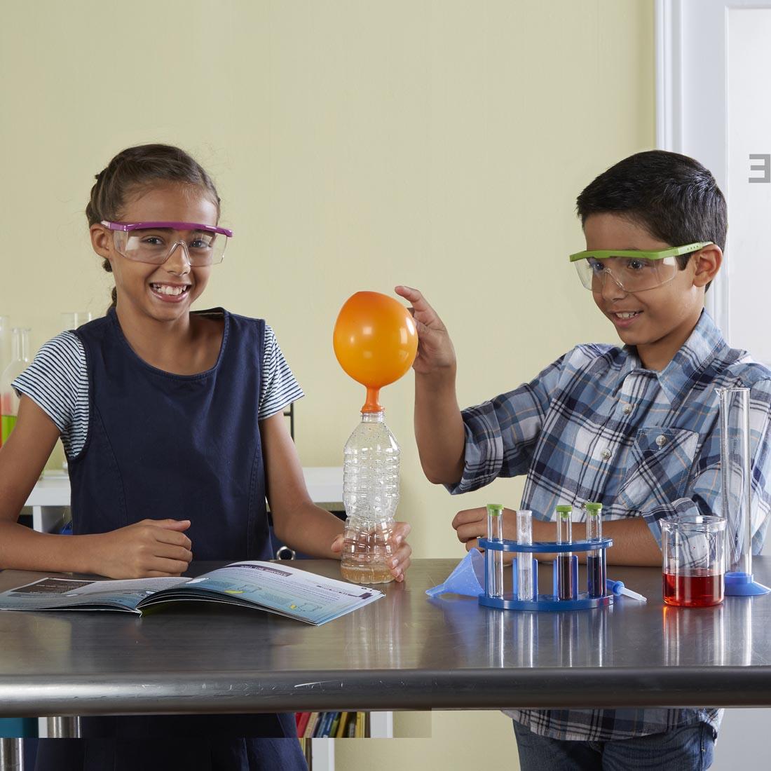children conducting a balloon experiment using GeoSafari Rockin' Reactions Chemistry Set