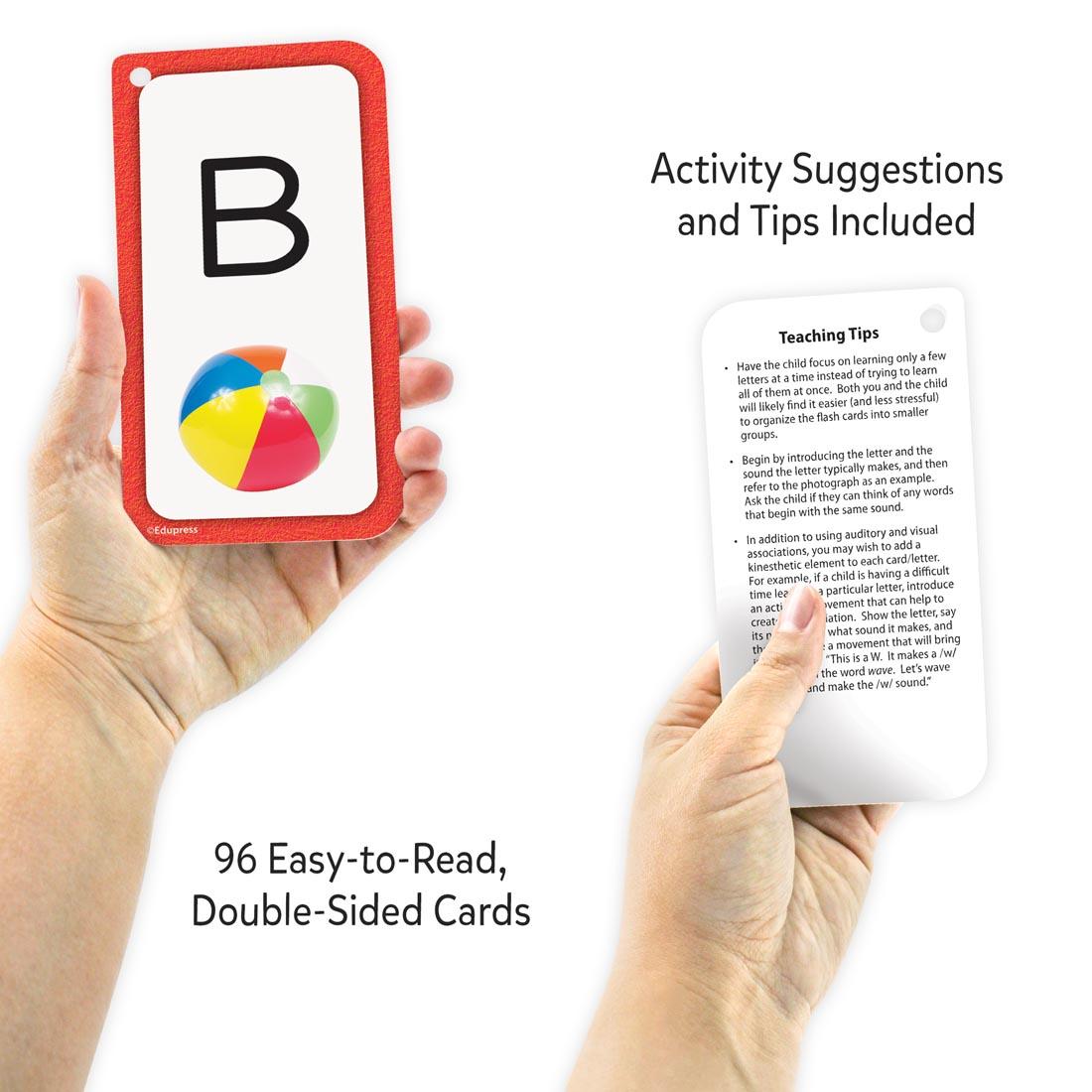 hands holding 2 cards from the Alphabet Flash Cards Deluxe Set plus text Activity suggestions and tips included; 96 easy-to-read, double-sided cards