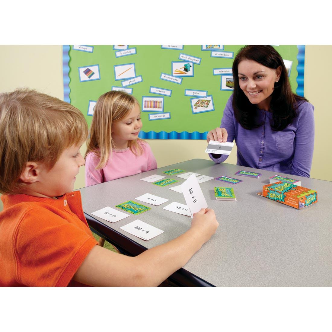 adult with two children playing the Division Splat Math Game