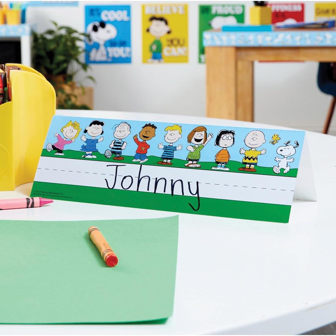 desk with a Tented Name Plate from the Peanuts collection by Eureka with a name written on it