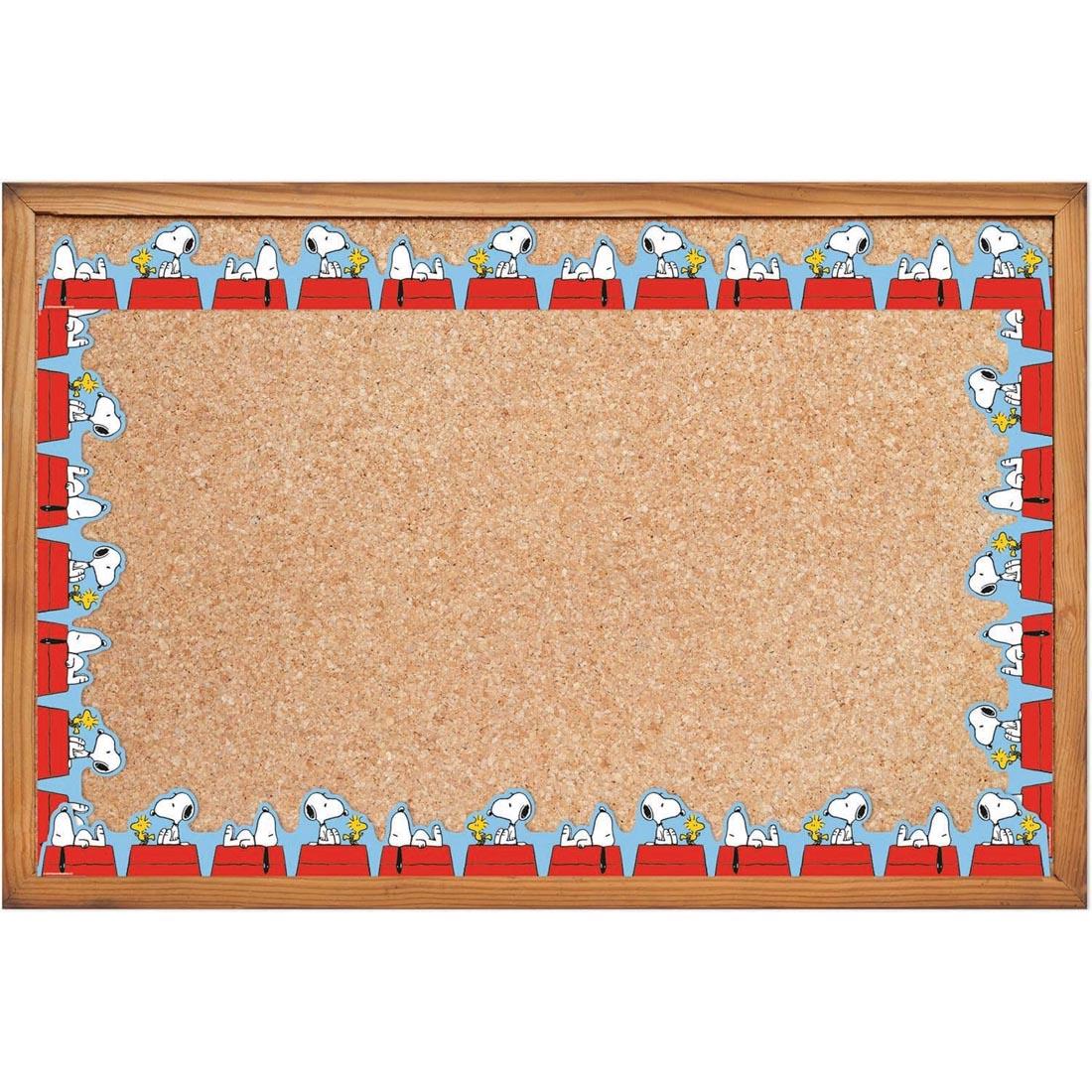 bulletin board bordered with Snoopy Doghouse Extra Wide Deco Trim from the Peanuts collection by Eureka