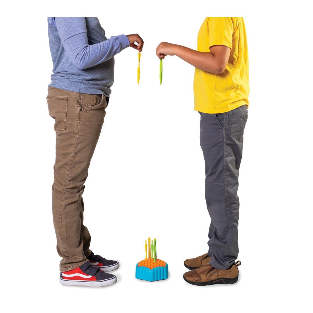 two people facing each other standing over the Drop Shot Game