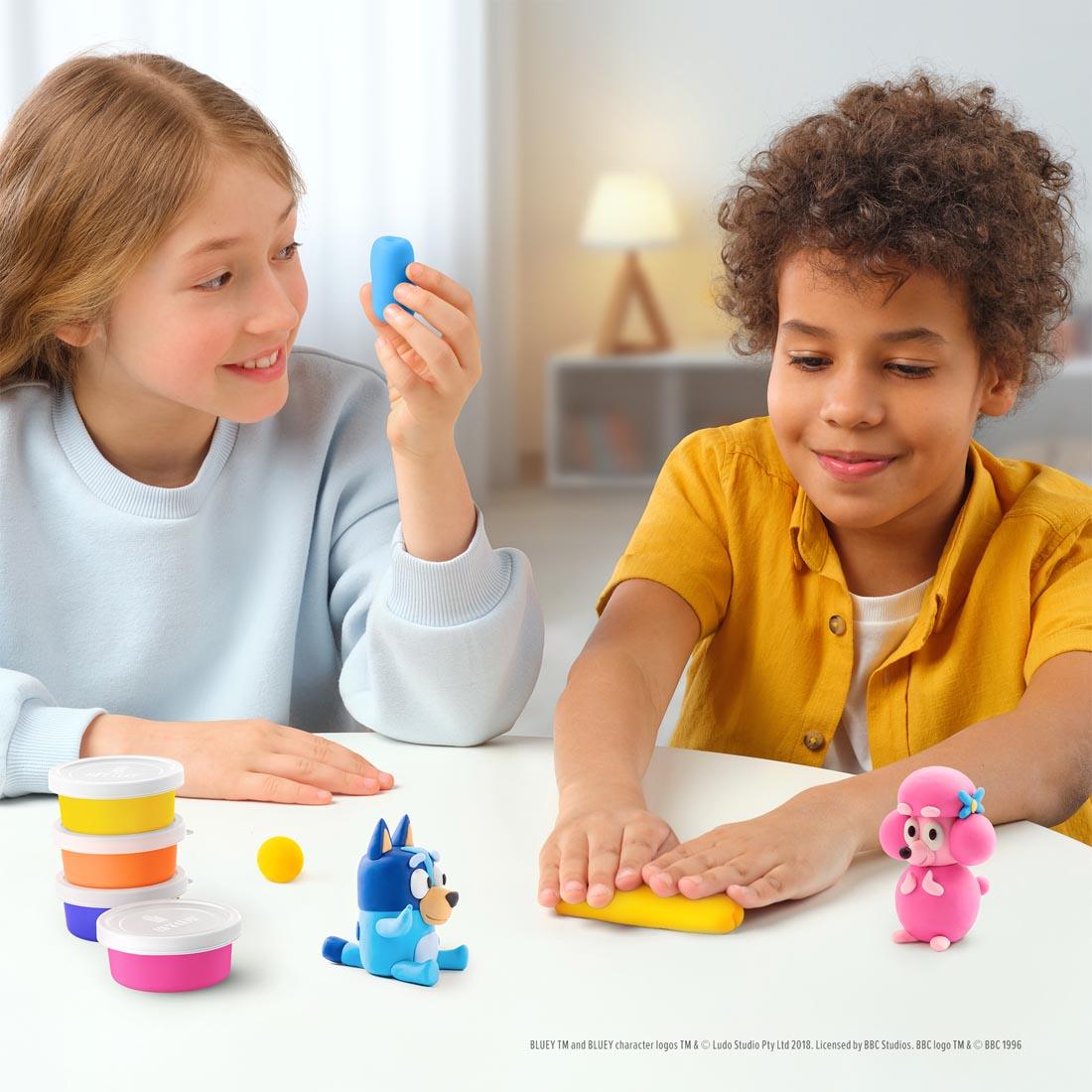 two kids using the Hey Clay Bluey & Friends Set By Fat Brain Toys
