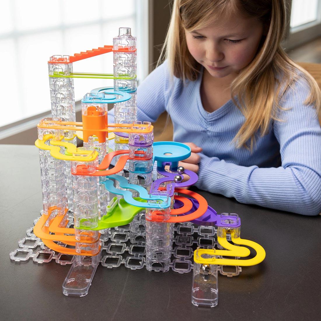 child playing with Trestle Tracks 124-Piece Deluxe Set