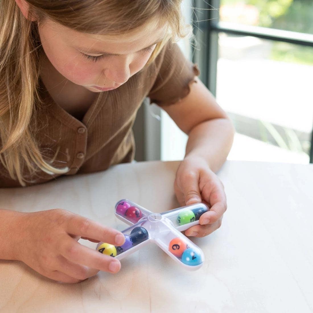 child playing with Tiltago Game