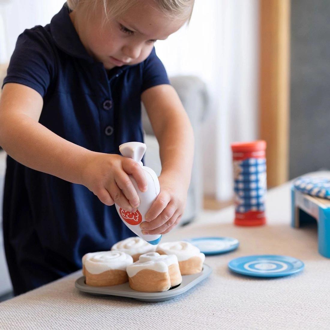 child playing with Pretendables Cinnamon Roll Set