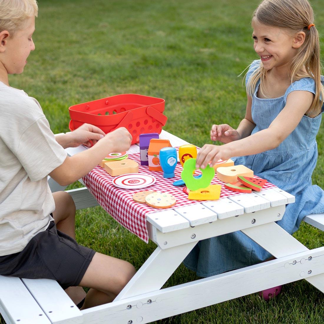 2 children playing with the Pretendables Picnic Basket Set