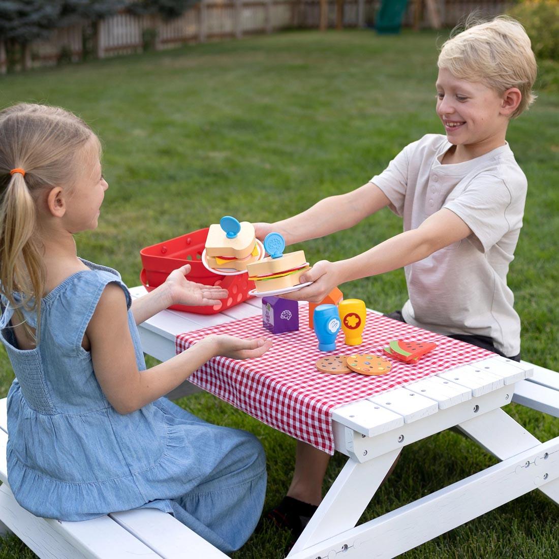 two children playing with the Pretendables Picnic Basket Set