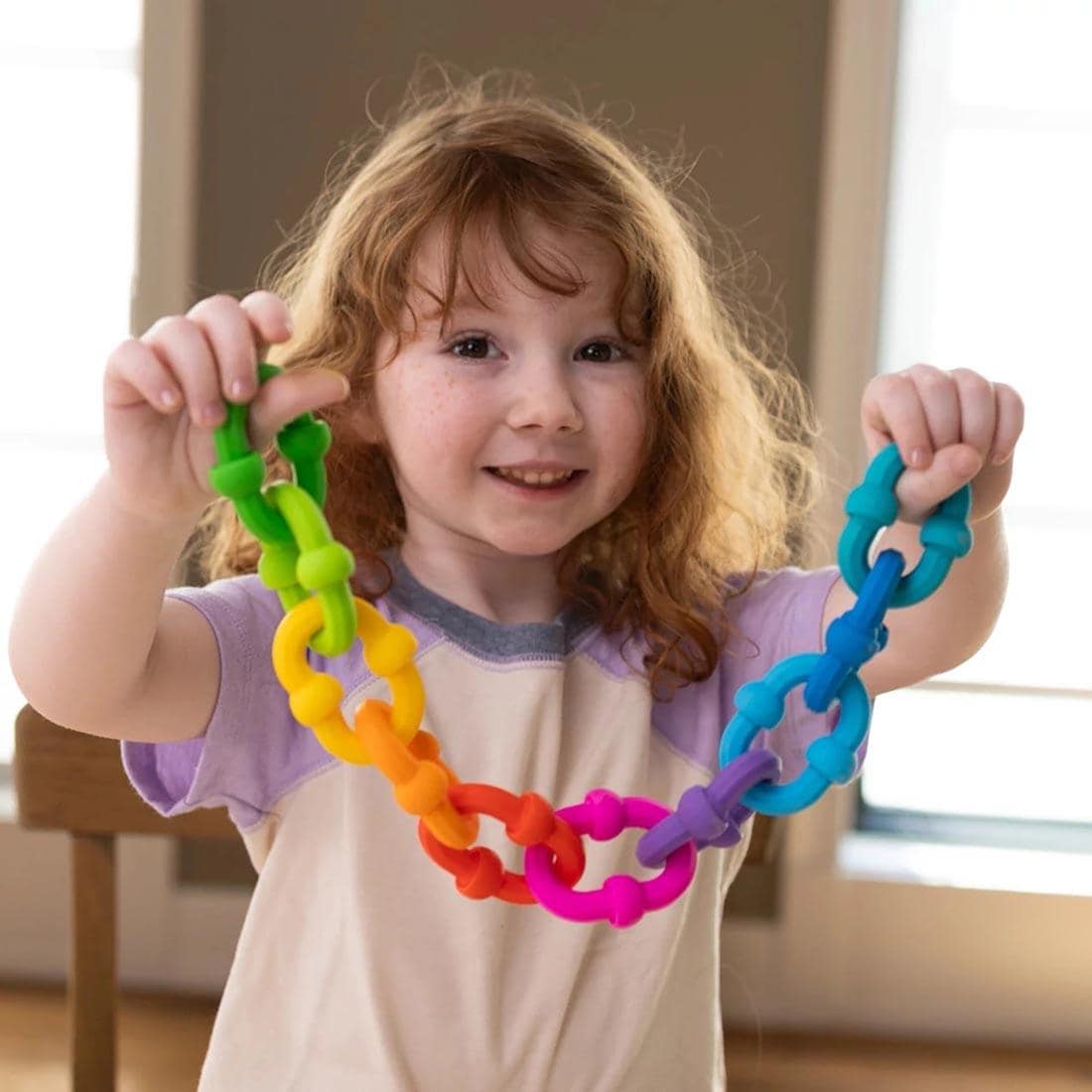 child holding a chain made with Plip Links