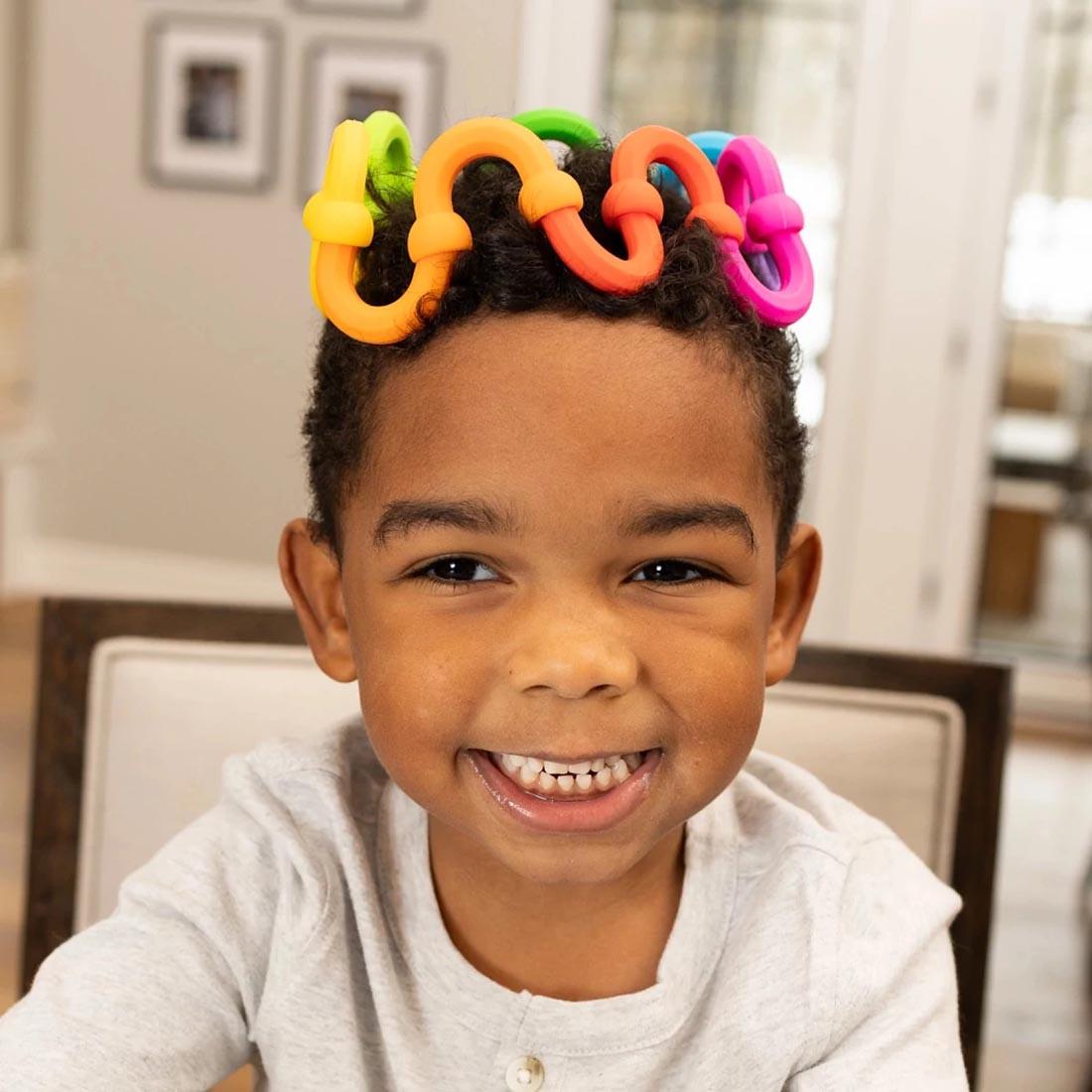 child wearing a crown made of Plip Links