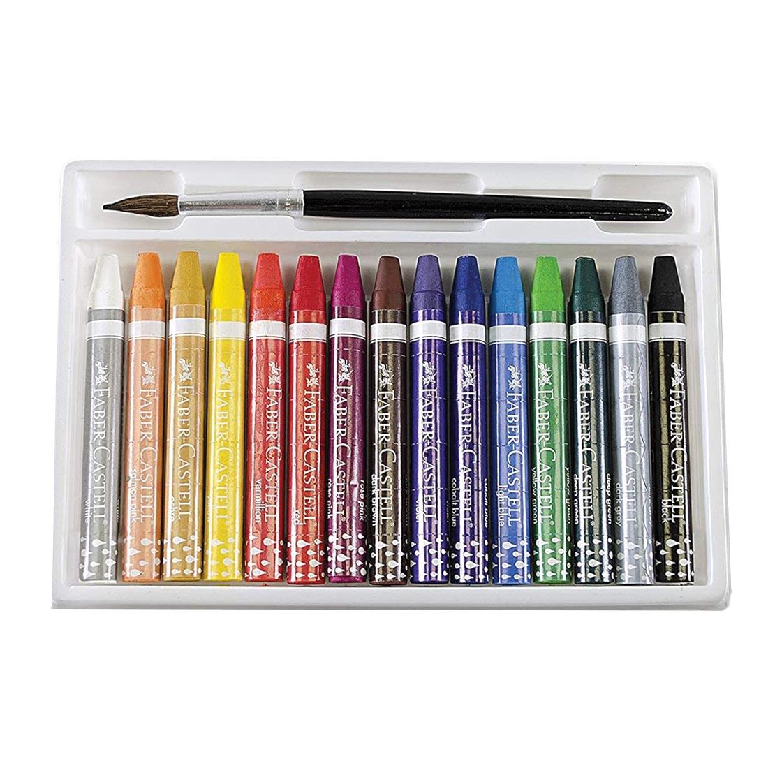 tray holding 15 Faber-Castell water color crayons and a painbrush