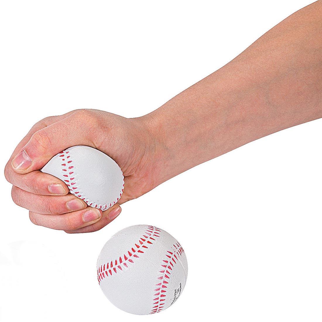 two Foam Realistic Baseball Stress Balls by Fun Express with a hand squeezing one of them
