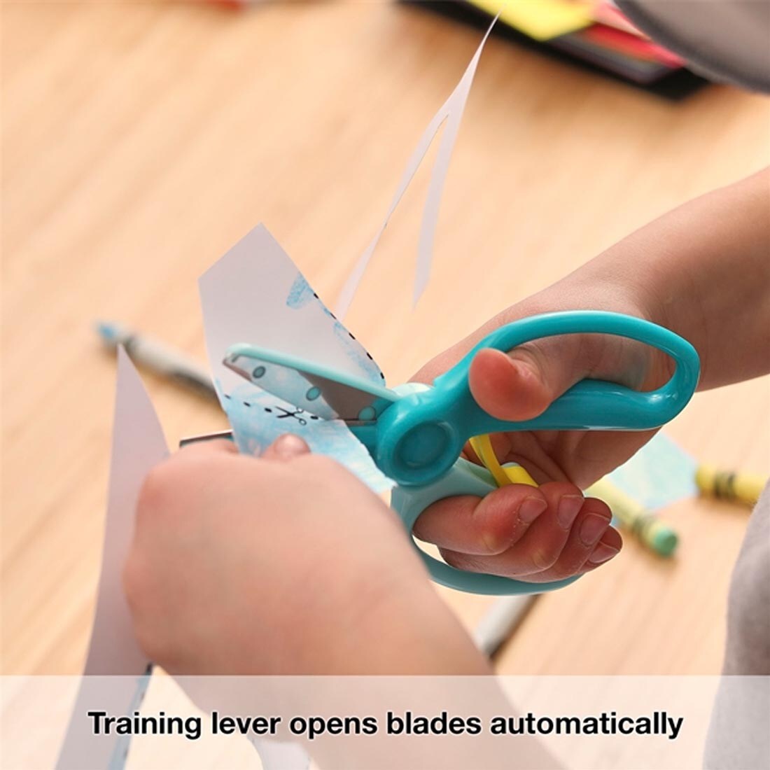 child using Fiskars Training Scissors with the text Training lever opens blades automatically