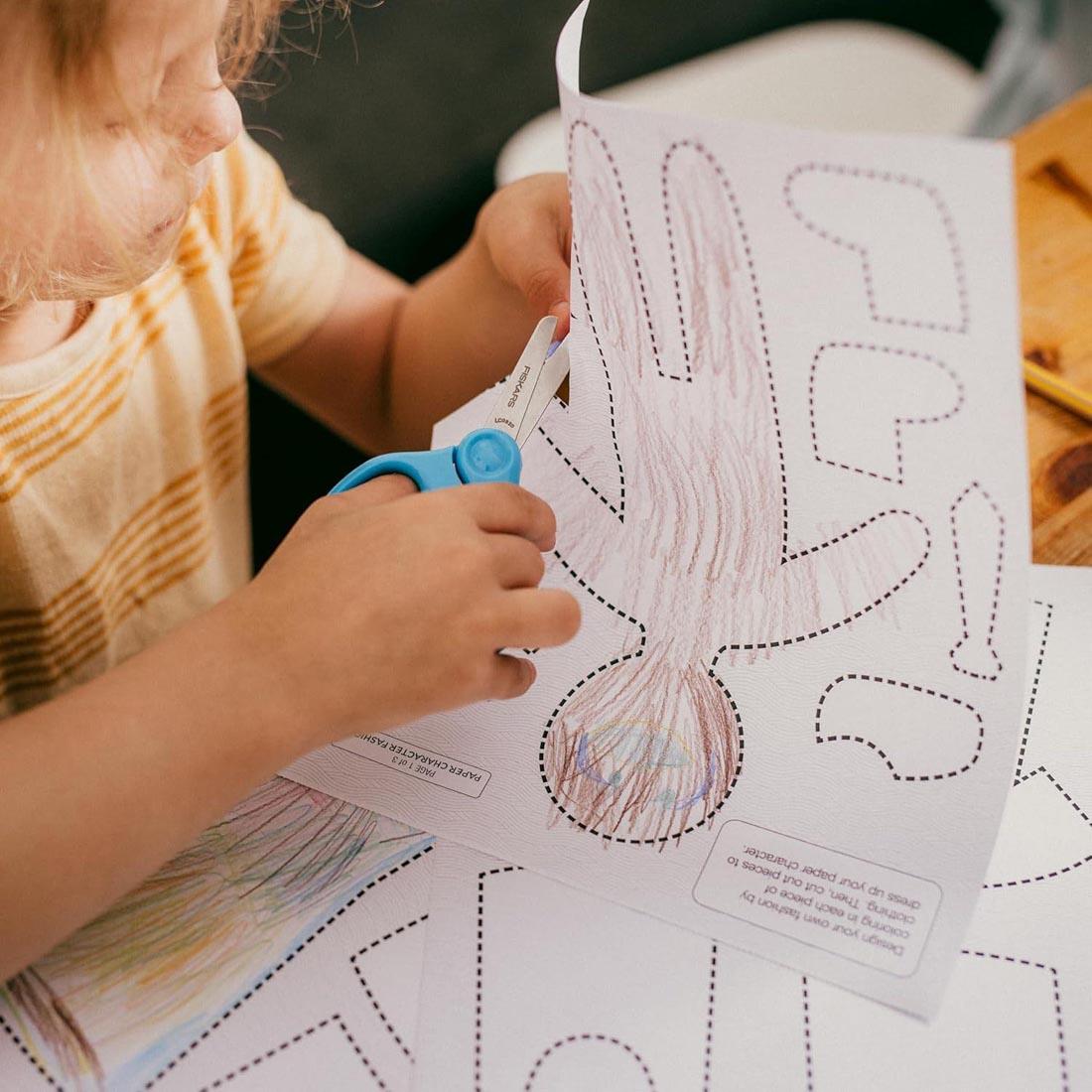 a child working with Fiskars Cut & Create Activity Book and Scissors Set For Ages 4+
